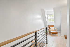 Hallway featuring light wood-type flooring and baseboards