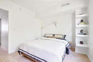 Bedroom with light wood-type flooring and baseboards
