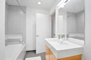 Full bath with vanity, shower / tub combination, and tile patterned floors
