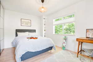 Bedroom featuring light wood-style floors and baseboards