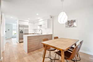 Dining space featuring light wood-type flooring and recessed lighting