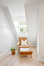Living area featuring light wood-style flooring and baseboards