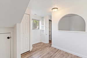 First basement bedroom and it has a small additional room you can see through the rounded window arch.
