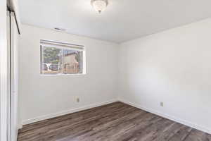 Bedroom 2 in the basement - from other side. Love that the windows are above ground so it's bright and not a dungeon.