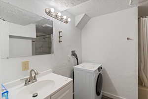 Basement bathroom with tub/shower and commode. The laundry unit it in here, too.