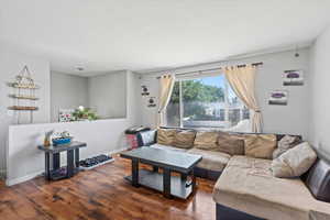 Living room featuring wood finished floors and a textured ceiling