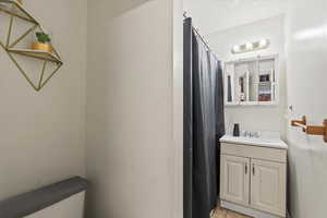 Full bathroom with vanity, tile patterned floors, and a shower with shower curtain