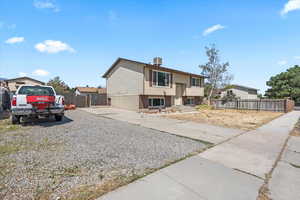 Raised ranch featuring gravel driveway