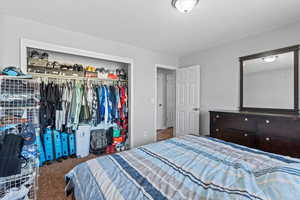 Carpeted bedroom with a closet