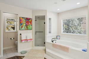Bathroom featuring a bath, a stall shower, tile patterned floors, and recessed lighting