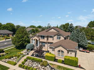 Traditional-style house featuring stucco siding, concrete driveway, and stone siding