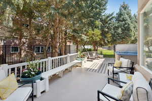Fenced backyard featuring a hot tub, a patio area, and an outdoor living space