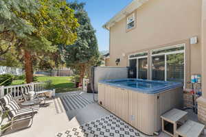 View of patio with a hot tub