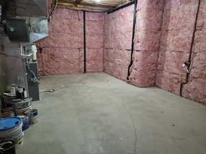 Unfinished below grade area with heating unit