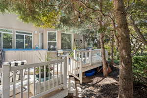 Wooden terrace with stairway and a hot tub