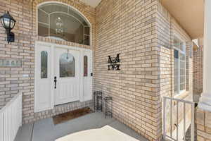 Entrance to property featuring brick siding