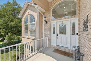 Doorway to property with brick siding