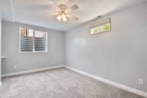 Unfurnished room featuring carpet flooring, a ceiling fan, and a textured ceiling