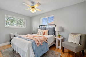 Bedroom with light wood finished floors and a ceiling fan