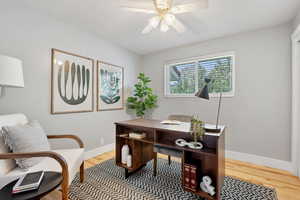Office with light wood finished floors and ceiling fan