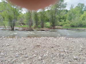 Water view with a heavily wooded area