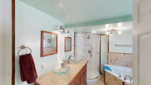 Full bathroom with a shower stall, vanity, and a garden tub