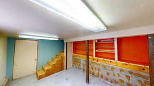Finished basement with a textured ceiling