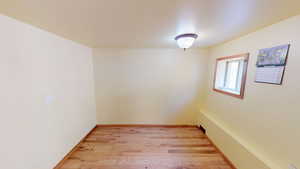 Spare room featuring light wood-style floors and baseboards