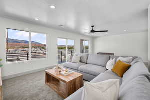 Carpeted living area featuring a mountain view, recessed lighting, and ceiling fan