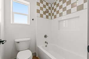 Bathroom with toilet and tub / shower combination