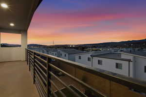 Balcony at dusk featuring a mountain view