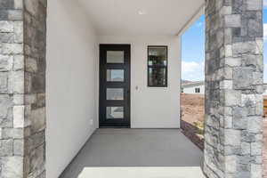 Doorway to property with stucco siding and stone siding