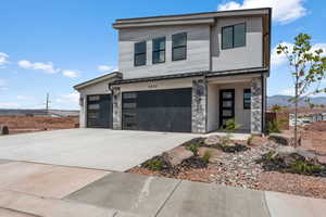 Contemporary home with a standing seam roof, a metal roof, and an attached garage