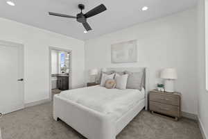 Carpeted bedroom with recessed lighting, ensuite bathroom, and a ceiling fan