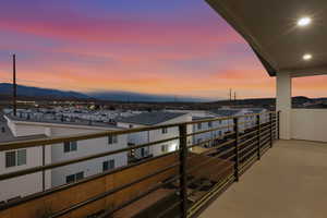 Balcony at dusk featuring a mountain view