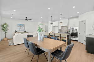 Dining area featuring light wood-style floors, recessed lighting, and a ceiling fan