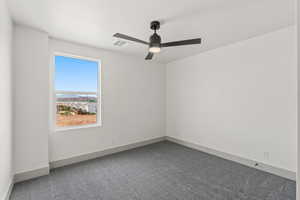Empty room with carpet and ceiling fan