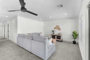 Living area featuring light carpet, recessed lighting, and ceiling fan