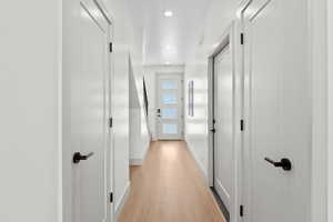 Hall featuring light wood-style flooring and recessed lighting