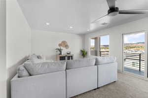Living room featuring carpet, a ceiling fan, and recessed lighting