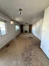 Unfurnished living room featuring a fireplace and ceiling fan