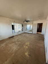 Empty room featuring a textured ceiling and a ceiling fan