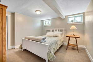 Carpeted bedroom with a textured ceiling