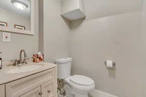 Half bathroom with toilet and vanity