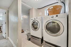 Laundry area featuring plenty of natural light, washing machine and dryer, and a textured ceiling