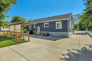 Back of property featuring a patio, a pergola, a mountain view, and brick siding