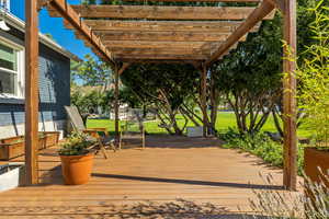 Deck with a pergola and a lawn