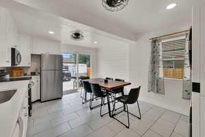 Dining area with recessed lighting and light tile patterned flooring