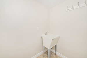Laundry room with baseboards and light tile patterned flooring