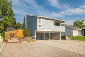 View of front of house featuring driveway and a carport